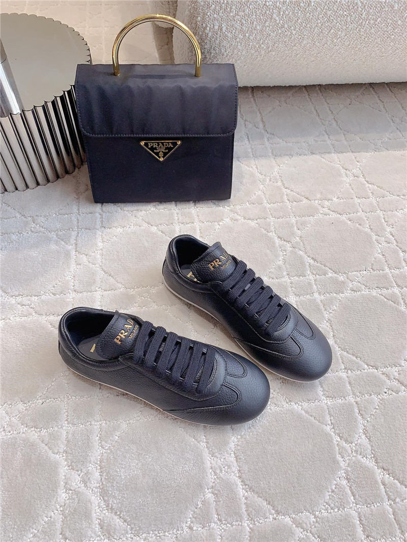 Pra*a triangle logo sneakers in black