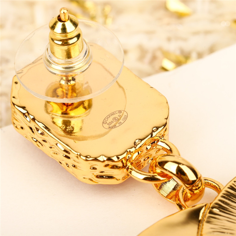 Ch**el enamel and gold relief earrings