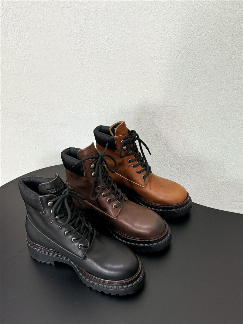 Pra*a black leather and re-nylon booties